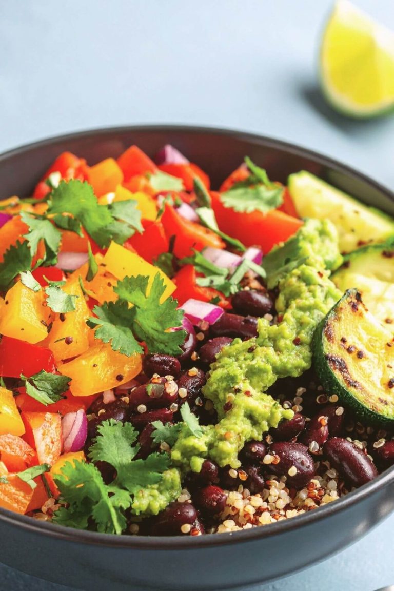 Vegan Burrito Bowl with Black Beans, quinoa, colorful peppers, zucchini, and guacamole