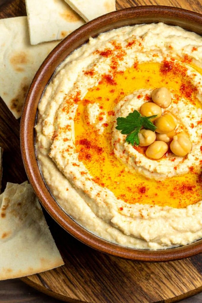 Bowl of Easy Hummus for snacks with pita bread and chips