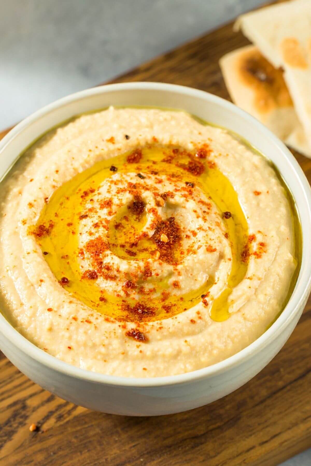 Bowl of Easy Hummus for snacks with pita bread and chips