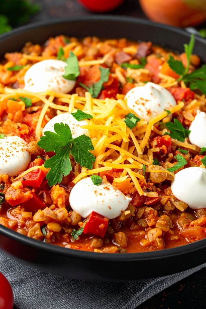vegan lentil chili topped with vegan sour cream