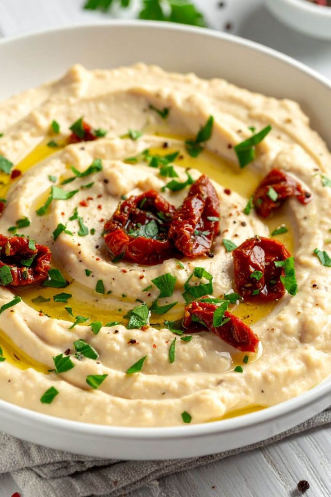 Bowl of White Bean Dip with Sundried Tomatoes in Marinade