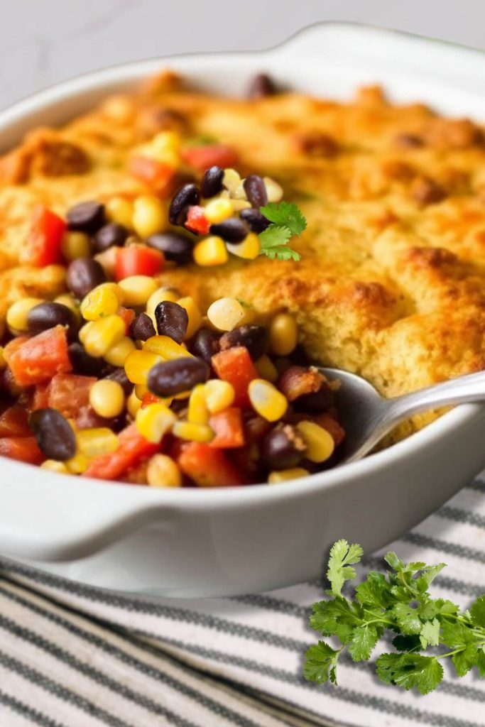 Vegan Black Bean Tamale Casserole garnished with corn, black beans, and cilantro