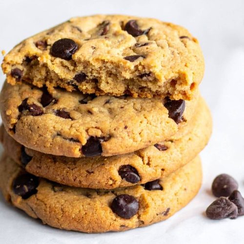Stack of Vegan Chocolate Chip Cookies with a half of a cookie on top