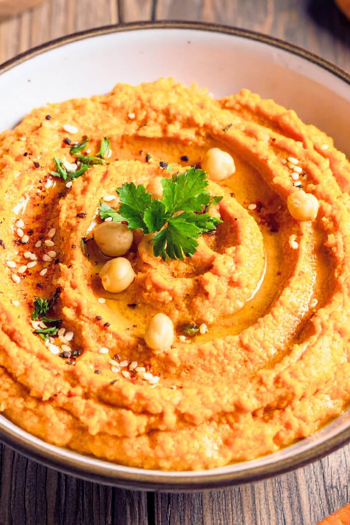 Bowl of Roasted Carrot Hummus for snacks and parties