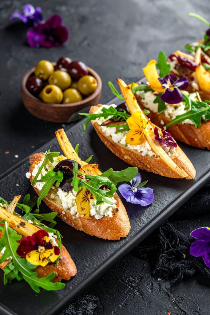 Roasted Parsnips and Garlic Crostini with pansy flower garnish