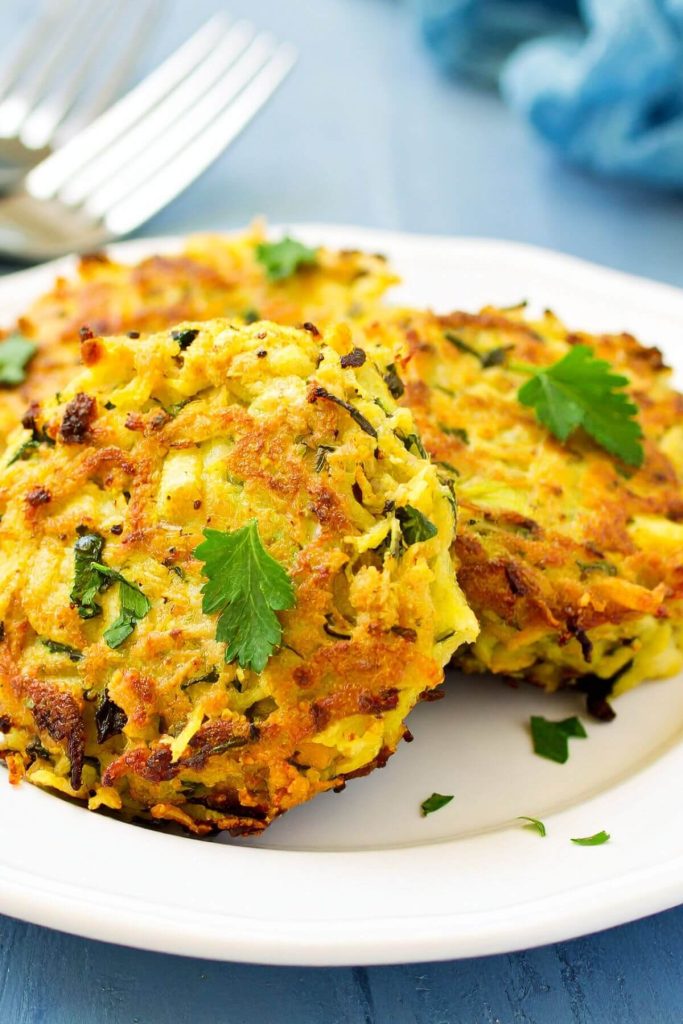 3 vegan crabcakes on a plate garnished with parsley