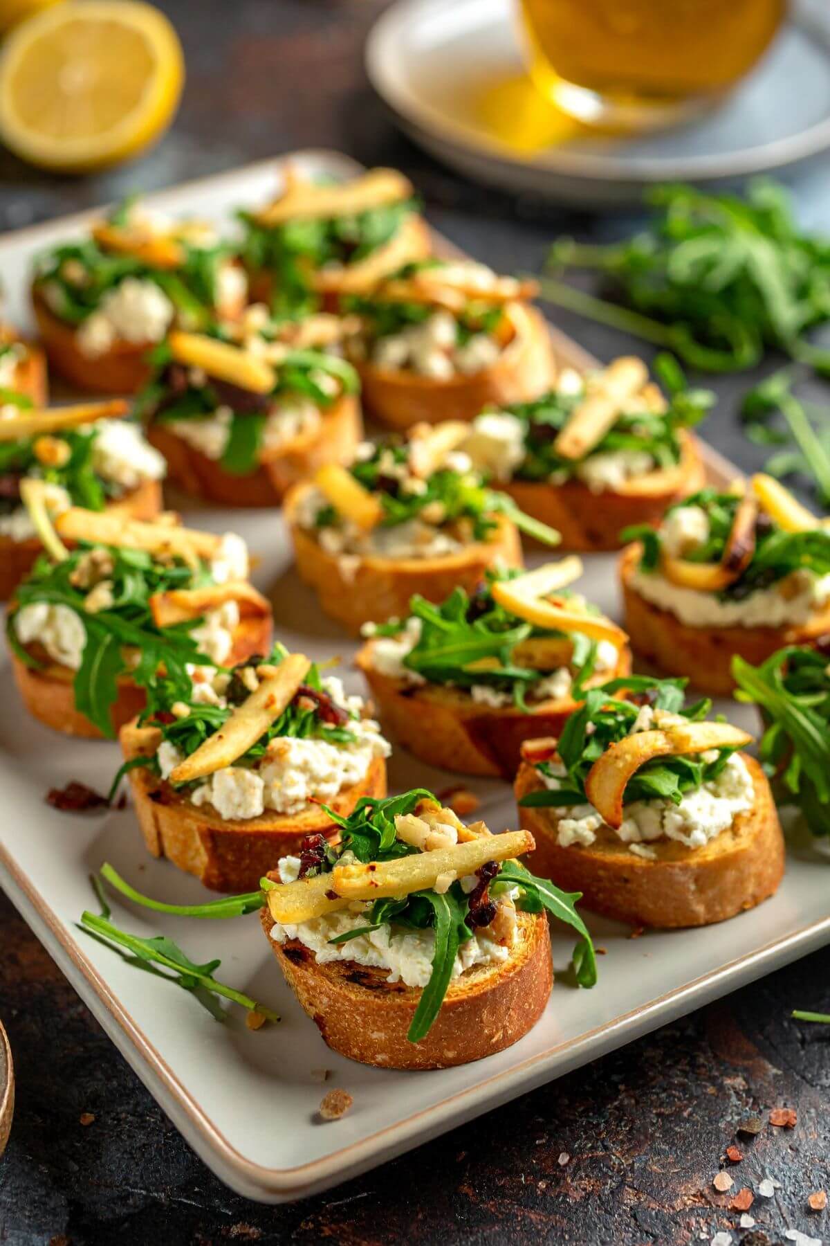 Roasted Parsnips and Garlic Crostini with Arugula on a tray for appetizers