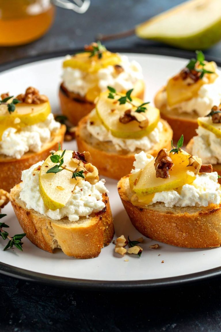 Pear, Walnut, Feta Crostini with maple and Thyme on a plate