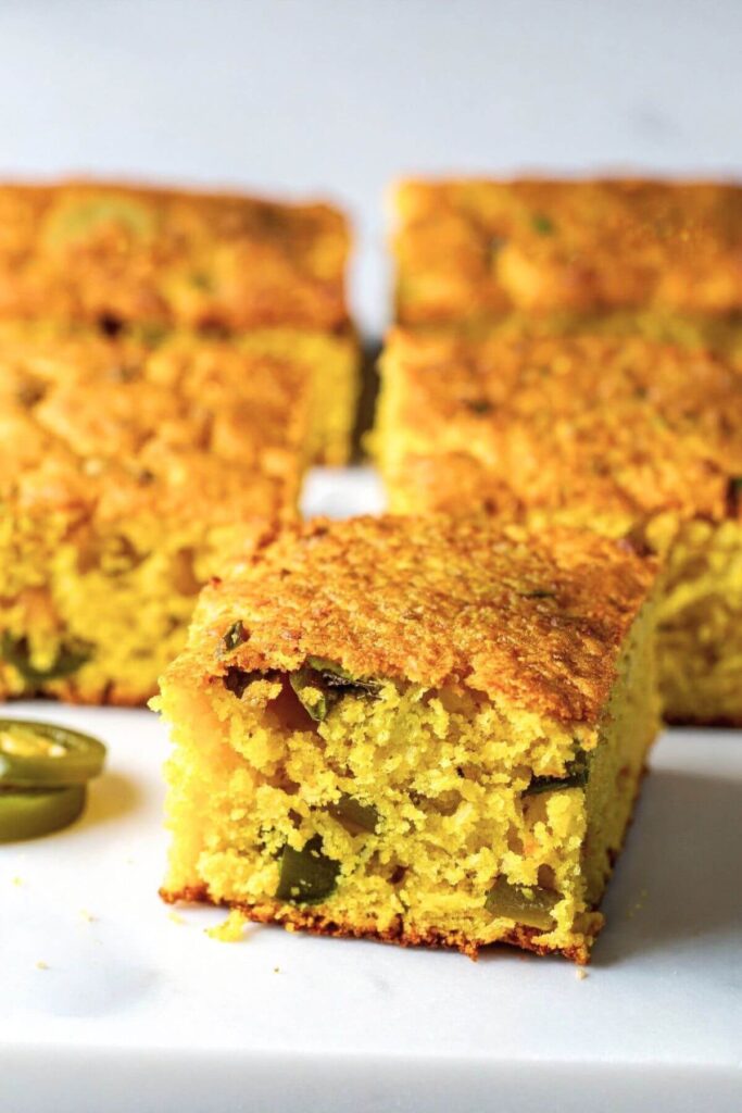 Close up of Vegan Jalapeno Cornbread cut into squares on a plate