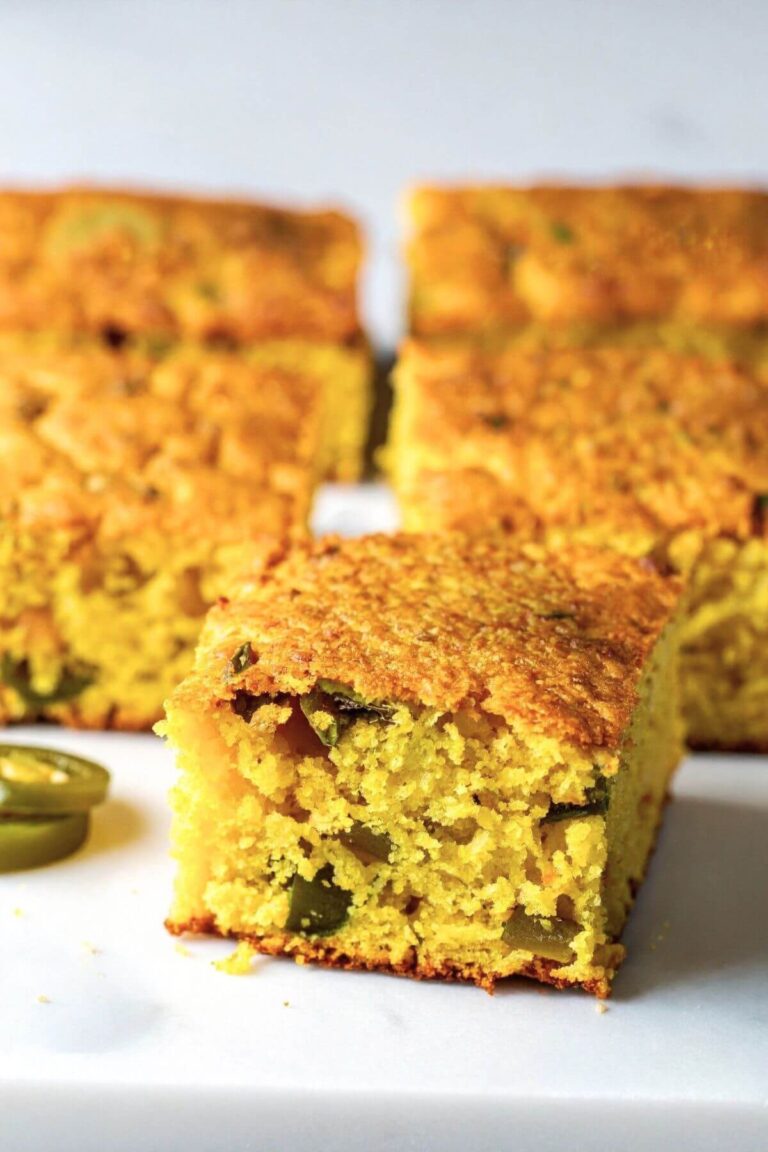 Close up of Vegan Jalapeno Cornbread cut into squares on a plate