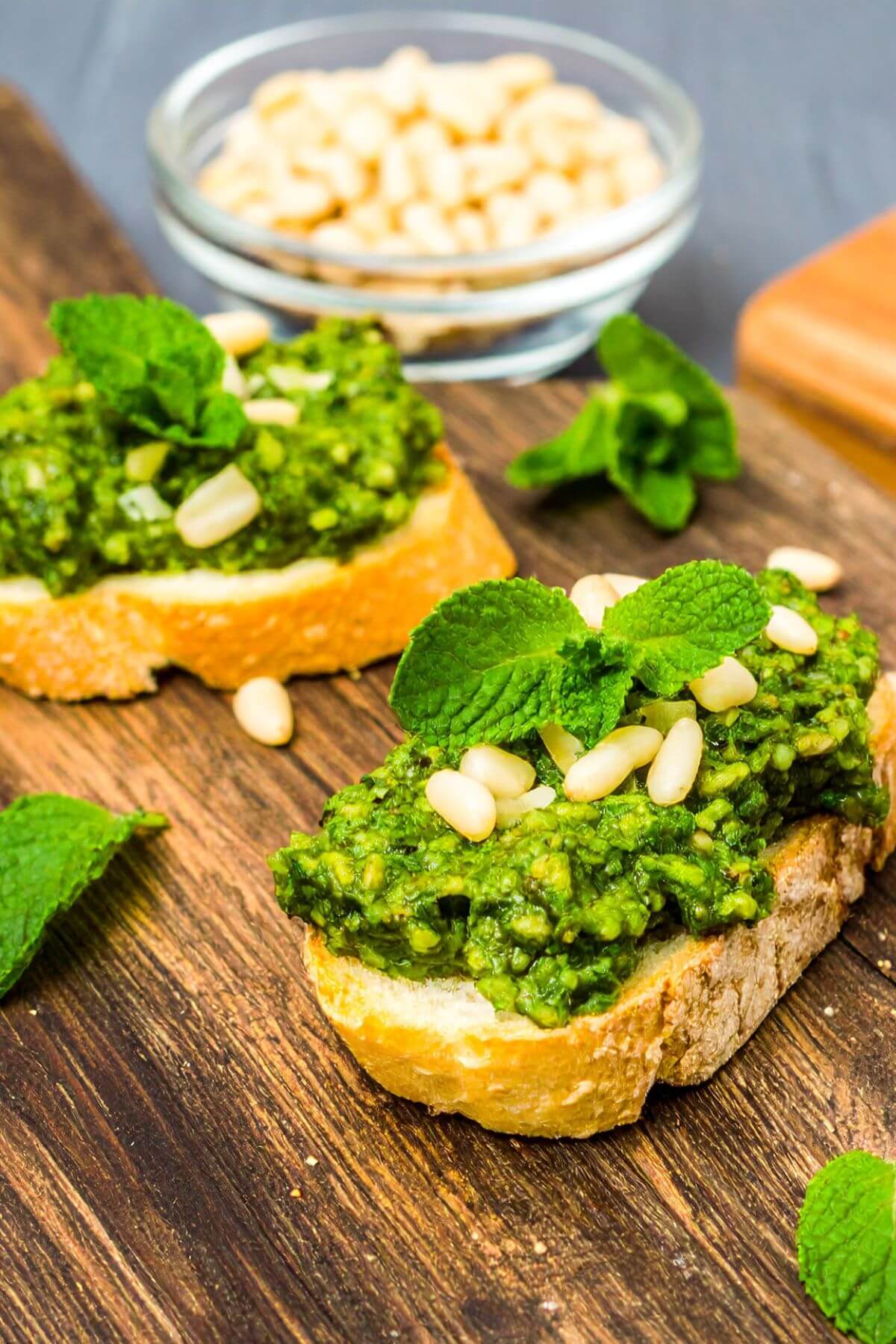 2 Pea Pesto Crostini garnished with pine nuts and mint