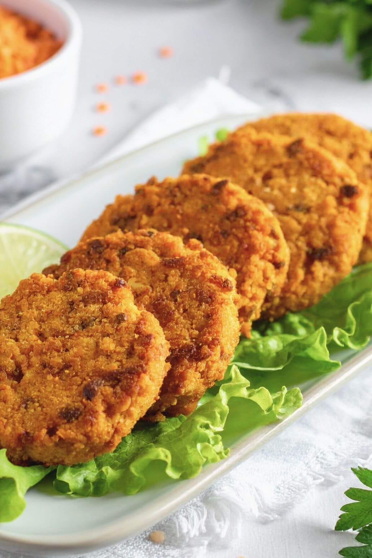 Platter of Vegan Red Lentil Patties on lettuce
