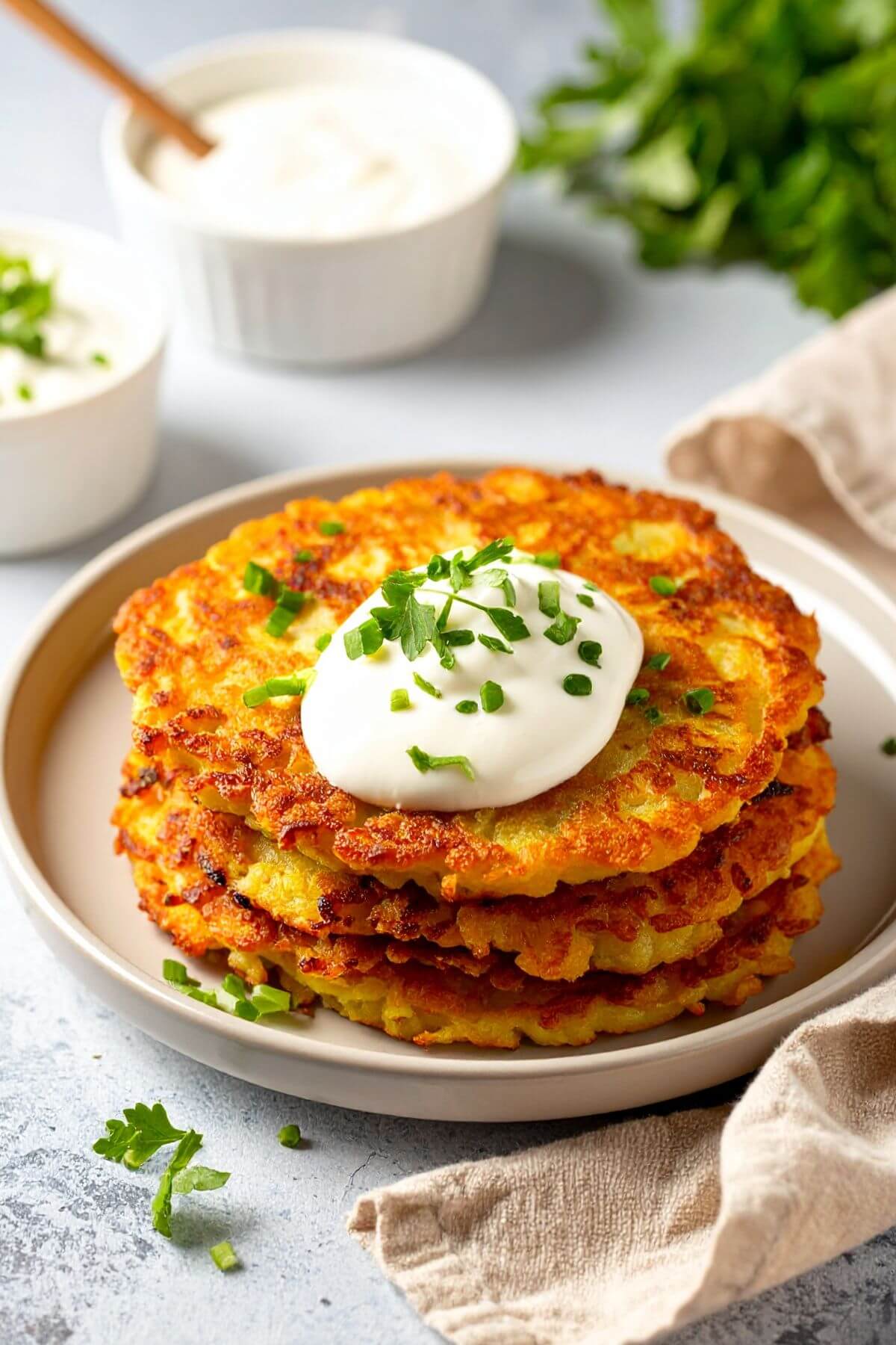 A stack of Vegan Irish Potato Packes garnished with vegan sour cream