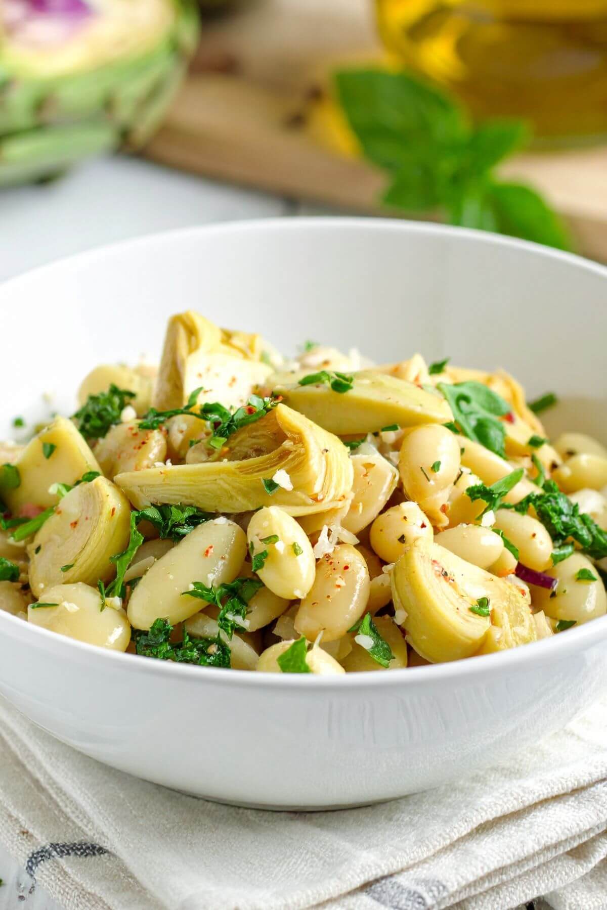A bowl white bean and artichoke salad