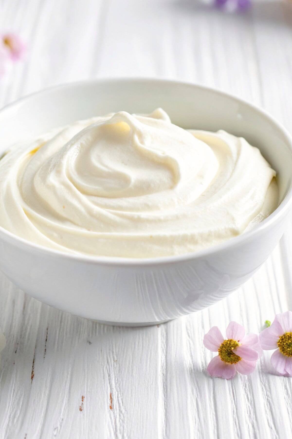 smooth vegan cream cheese frosting in a white bowl