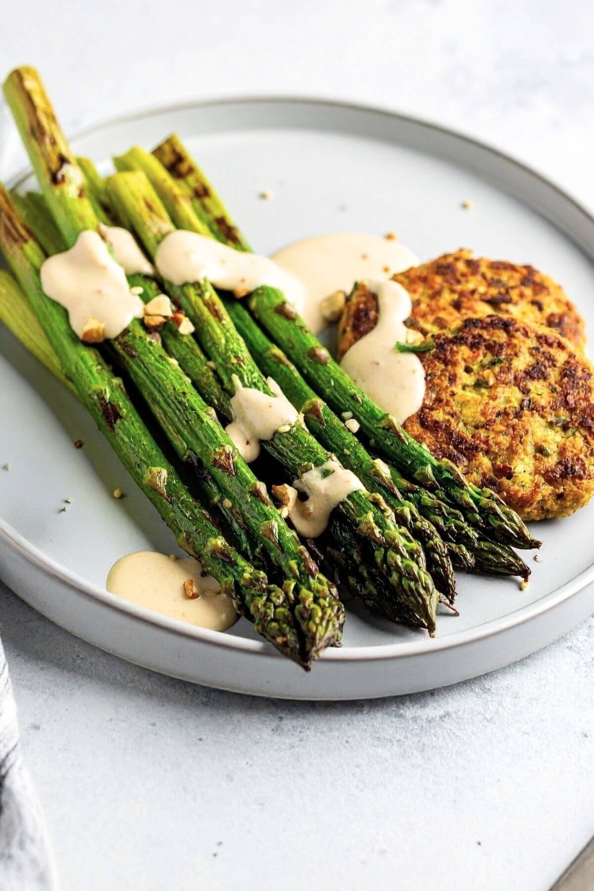 Simple roasted asparagus with creamy tahini and veggie patties for dinner