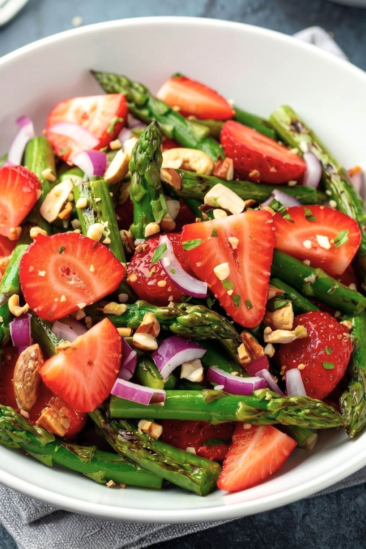 strawberry asparagus salad with mixed greens, red onion, and balsamic dressing