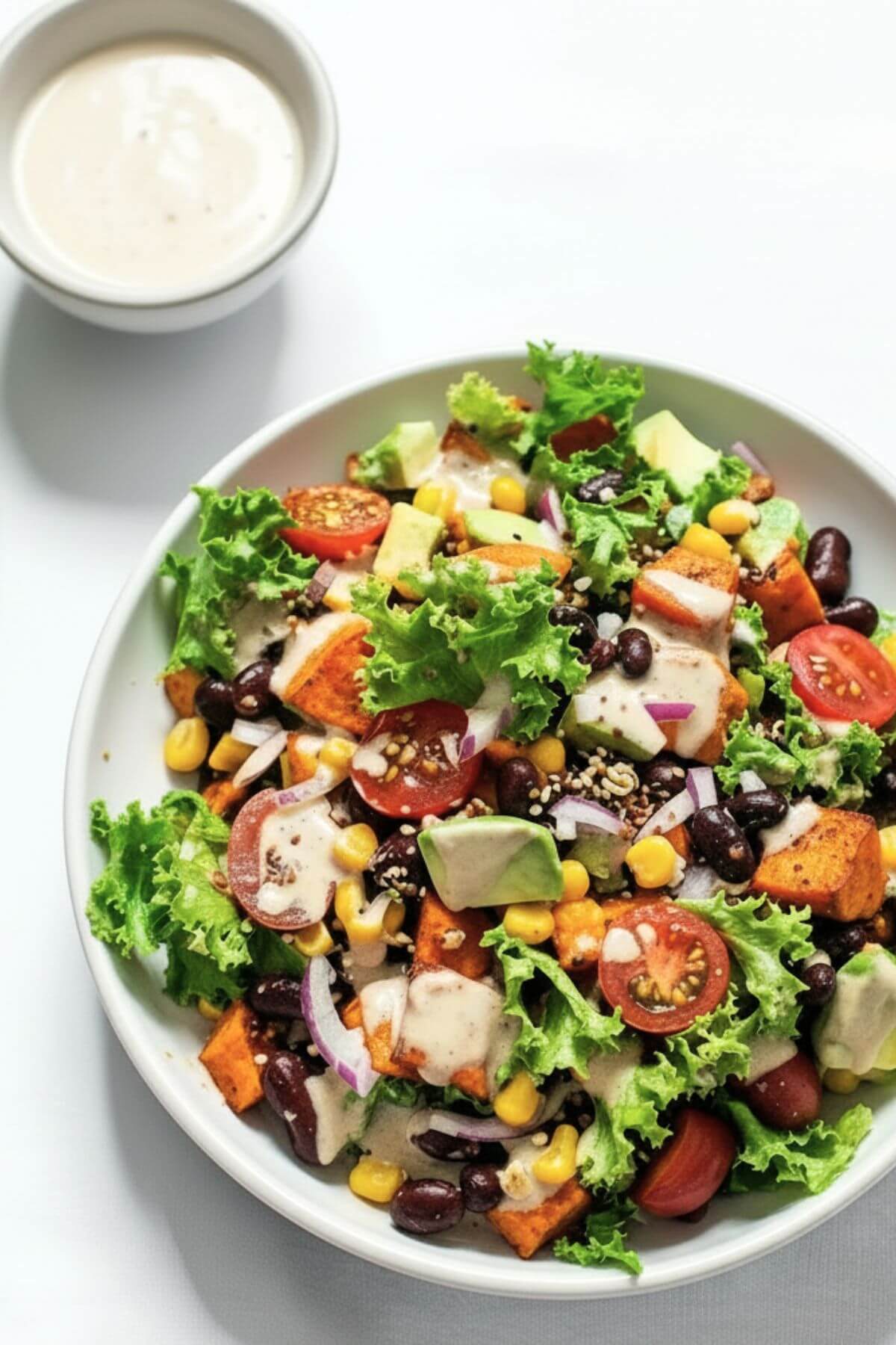 Black bean and roasted sweet potato taco salad with avocado and greens