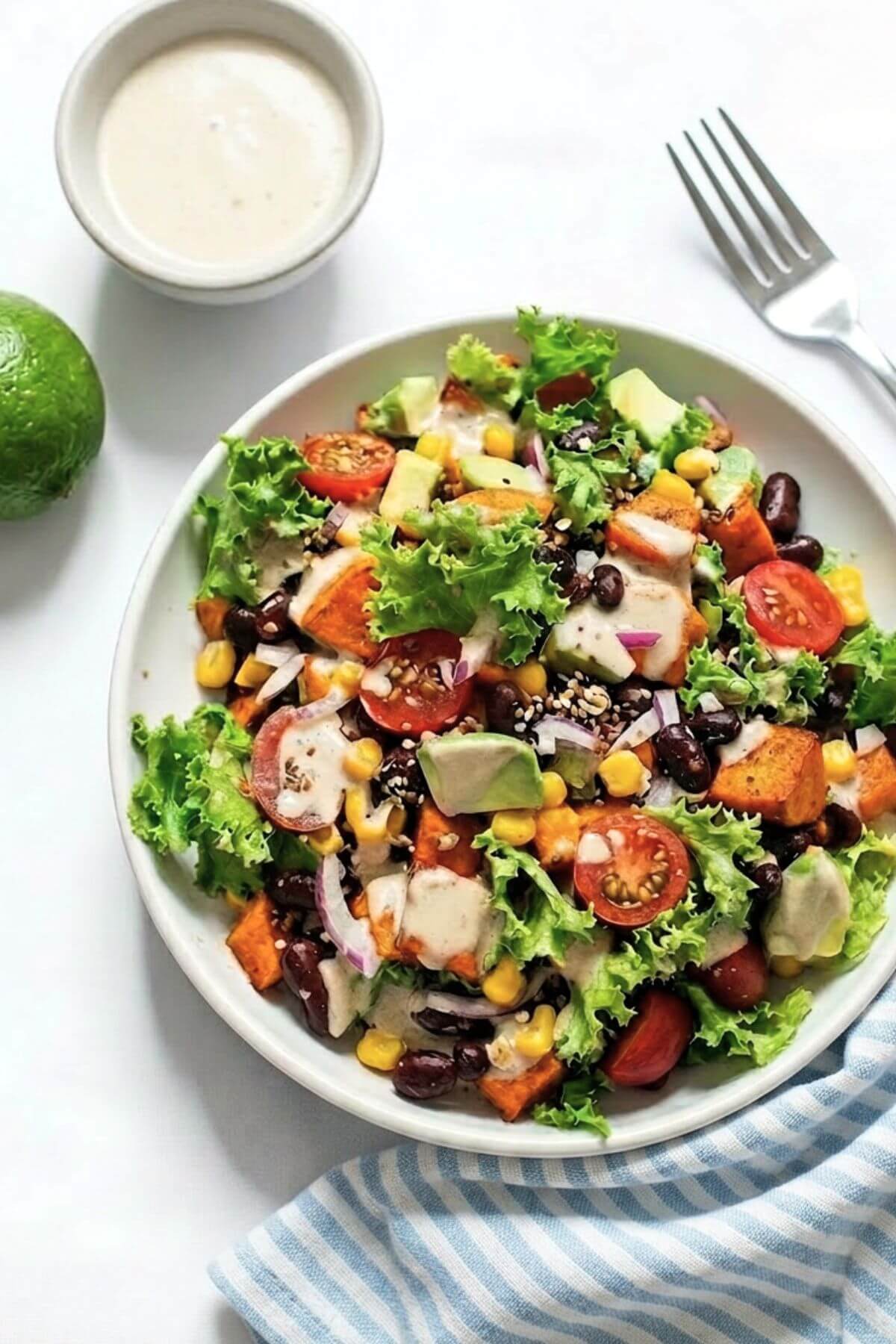 Black bean and roasted sweet potato taco salad with avocado and greens