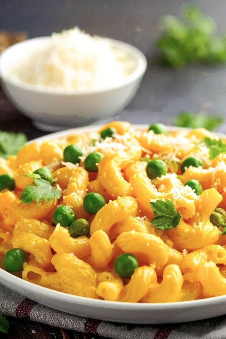 Plate of no-nut, vegan, gluten-free butternut squash macaroni and cheese with peas.