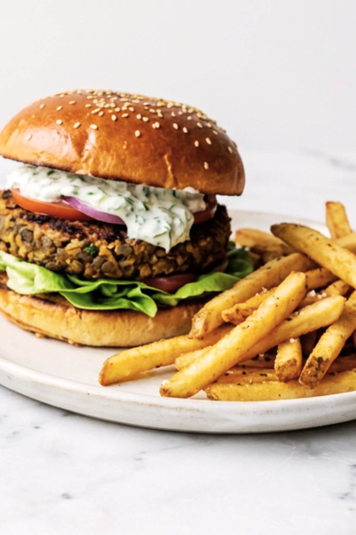 Vegan Lentil Burger with french fries on ths side.